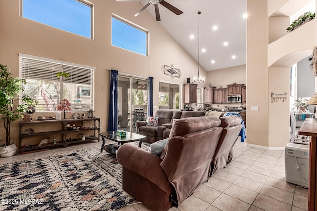 living room featuring light tile patterned flooring, a ceiling fan, high vaulted ceiling, and arched walkways