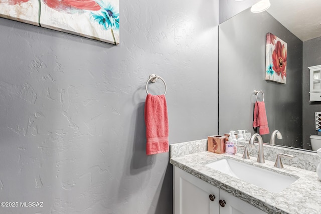 bathroom with toilet and vanity