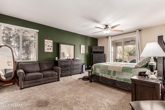 carpeted bedroom with ceiling fan and access to outside