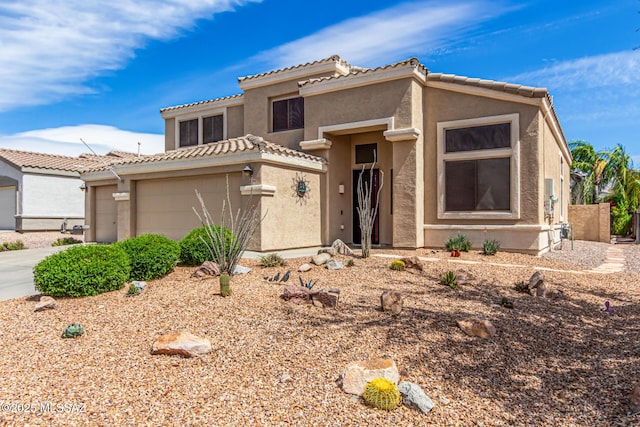 view of front facade with stucco siding, concrete driveway, and an attached garage