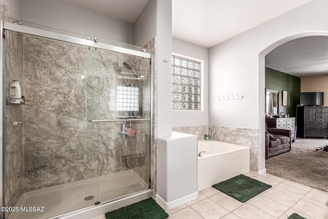 full bathroom with tile patterned floors, a shower stall, and a garden tub