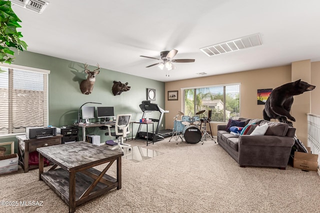 carpeted living area featuring visible vents and ceiling fan