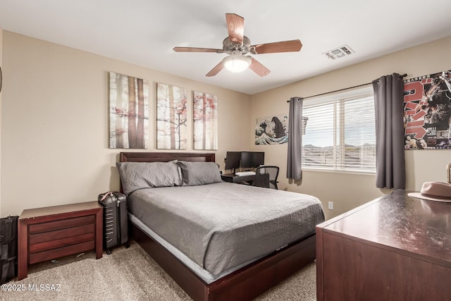 carpeted bedroom featuring a ceiling fan and visible vents