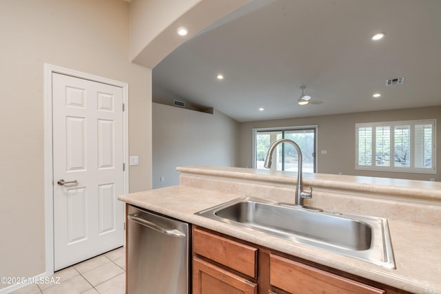 kitchen with stainless steel dishwasher, a sink, visible vents, and light tile patterned floors