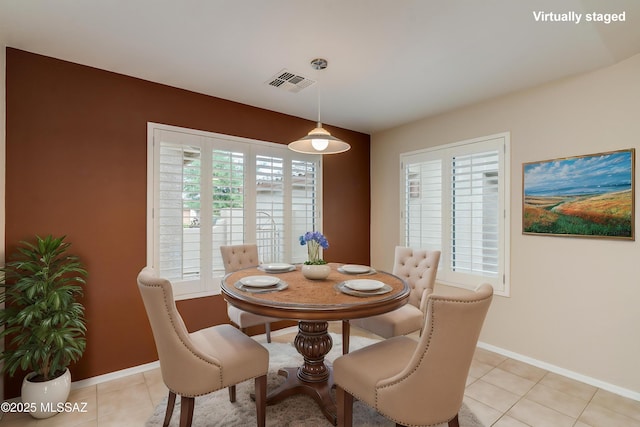 dining room with visible vents, baseboards, and light tile patterned floors