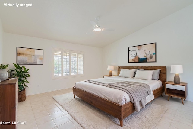 bedroom with vaulted ceiling, baseboards, a ceiling fan, and light tile patterned flooring