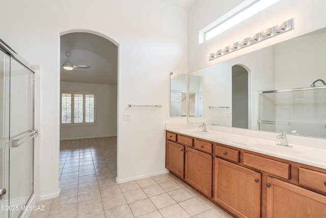 full bath featuring tile patterned floors, a shower with shower door, a sink, and plenty of natural light