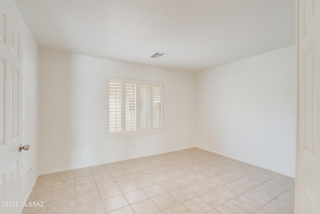 unfurnished room featuring visible vents and light tile patterned floors