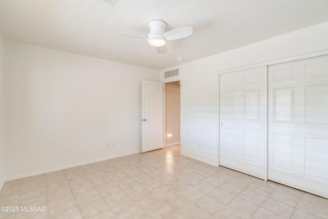 unfurnished bedroom with a closet, visible vents, a ceiling fan, and baseboards