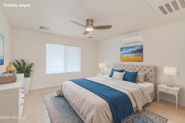 bedroom featuring light tile patterned floors, ceiling fan, visible vents, and a wall unit AC