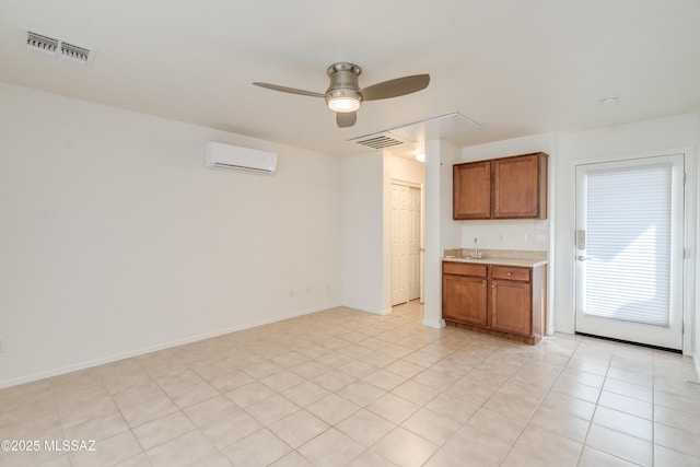 interior space with ceiling fan, baseboards, visible vents, and a wall unit AC