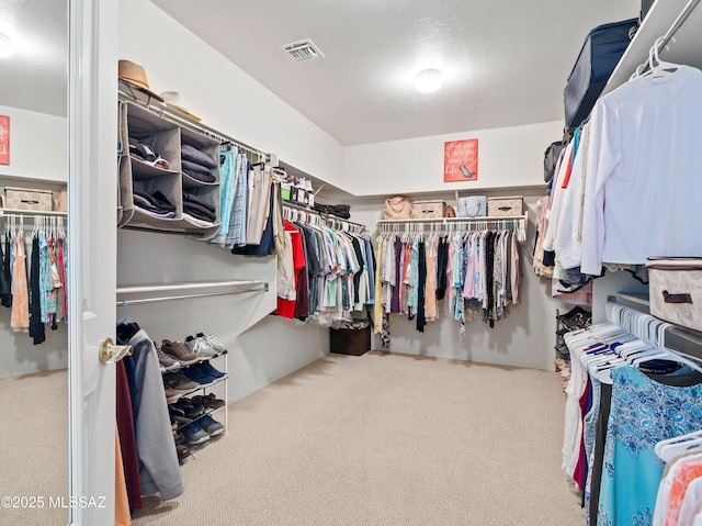 spacious closet with visible vents and carpet floors