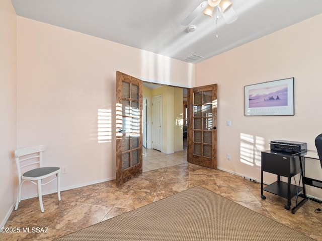 entrance foyer with baseboards, stone finish floor, a ceiling fan, and french doors