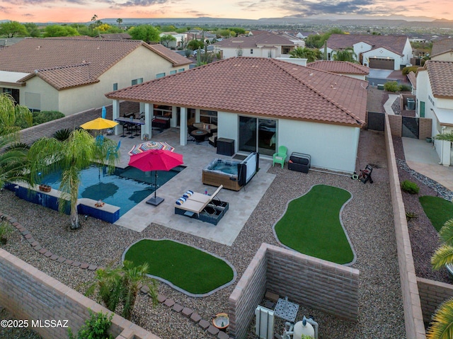 back of property with an outdoor living space, a fenced backyard, stucco siding, a patio, and a residential view