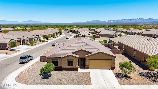 birds eye view of property with a mountain view and a residential view