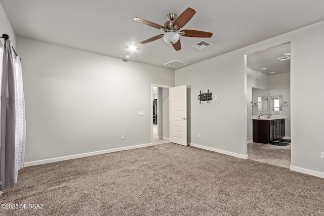 unfurnished bedroom featuring visible vents, baseboards, light carpet, and connected bathroom