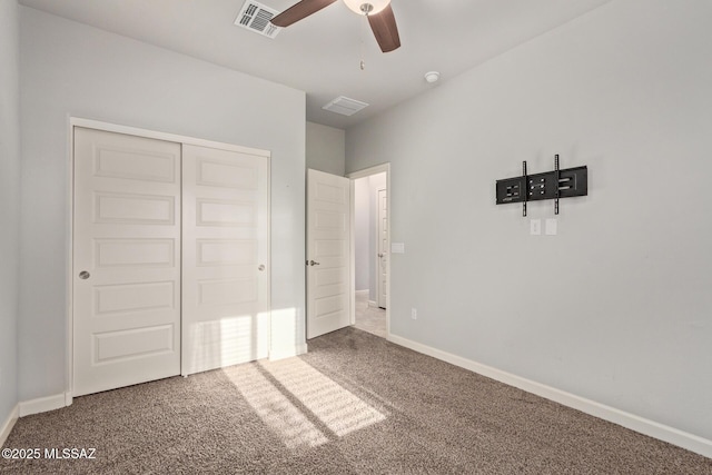 unfurnished bedroom with a closet, carpet, visible vents, and baseboards