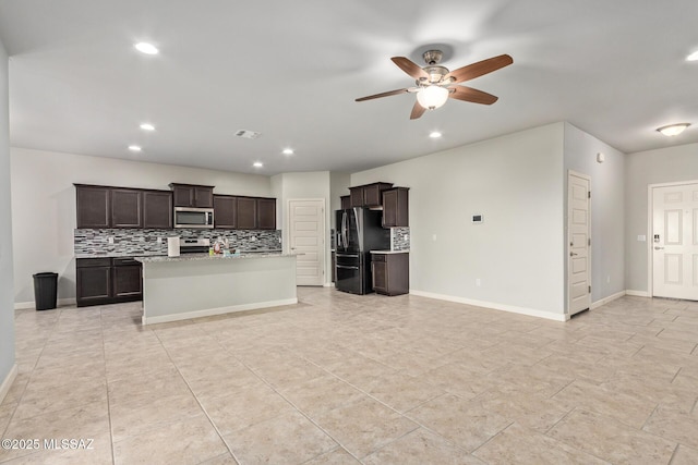 kitchen featuring light countertops, tasteful backsplash, appliances with stainless steel finishes, and ceiling fan