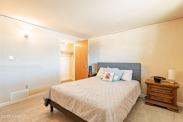 bedroom featuring visible vents, wood finished floors, and baseboards