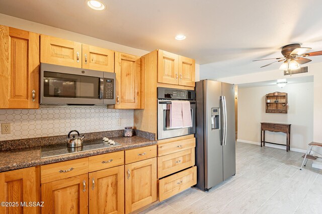 kitchen featuring backsplash, visible vents, baseboards, appliances with stainless steel finishes, and ceiling fan