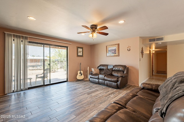 living area featuring wood finished floors, a ceiling fan, visible vents, and recessed lighting