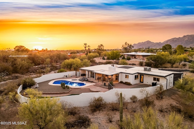 3855 N Via Avellana, Tucson, AZ 85718 - back of property featuring a fenced backyard, a patio area, an outdoor pool, and a mountain view