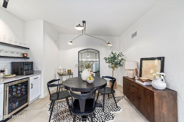 3855 N Via Avellana, Tucson, AZ 85718 - dining space with beverage cooler, a dry bar, and light tile patterned floors