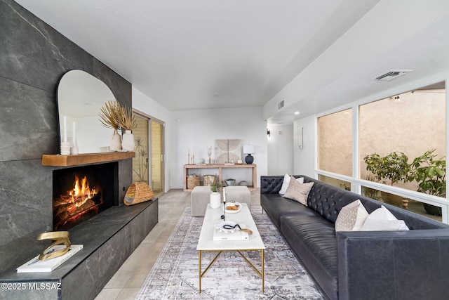 3855 N Via Avellana, Tucson, AZ 85718 - living room featuring a warm lit fireplace and light tile patterned floors