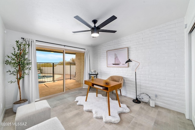 3855 N Via Avellana, Tucson, AZ 85718 - office space with brick wall, a ceiling fan, and baseboards