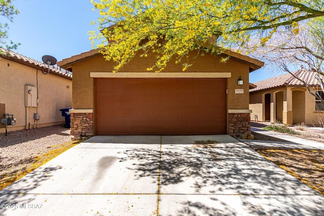 9528 S Desert Fauna Loop, Tucson, AZ 85747 - view of front of house with stucco siding, a tile roof, driveway, and stone siding