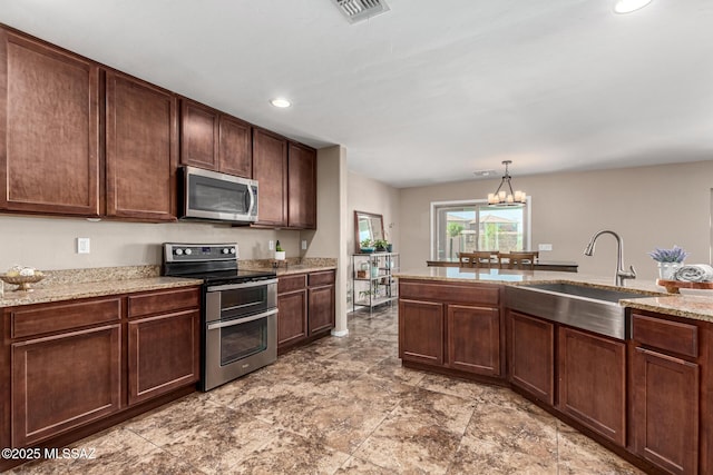 9528 S Desert Fauna Loop, Tucson, AZ 85747 - kitchen with light stone counters, a sink, stainless steel appliances, visible vents, and recessed lighting