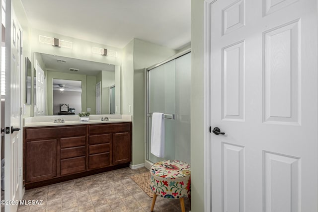 9528 S Desert Fauna Loop, Tucson, AZ 85747 - full bathroom with a ceiling fan, a sink, a stall shower, double vanity, and visible vents