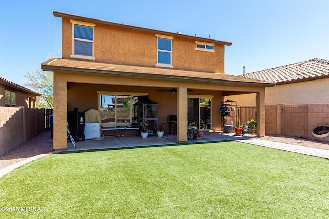 9528 S Desert Fauna Loop, Tucson, AZ 85747 - back of house featuring a lawn, a patio, a fenced backyard, and stucco siding