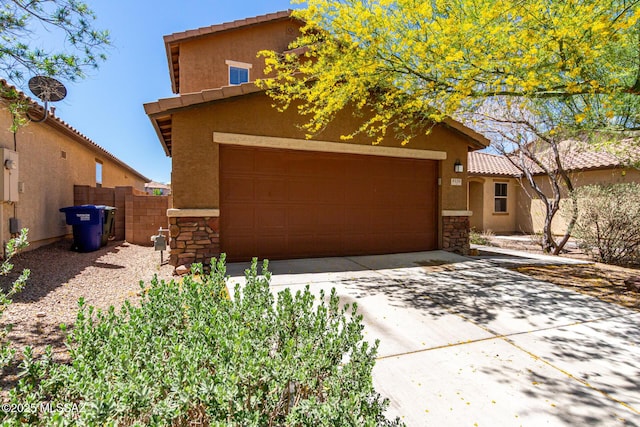 9528 S Desert Fauna Loop, Tucson, AZ 85747 - view of front facade featuring stone siding, concrete driveway, fence, and stucco siding