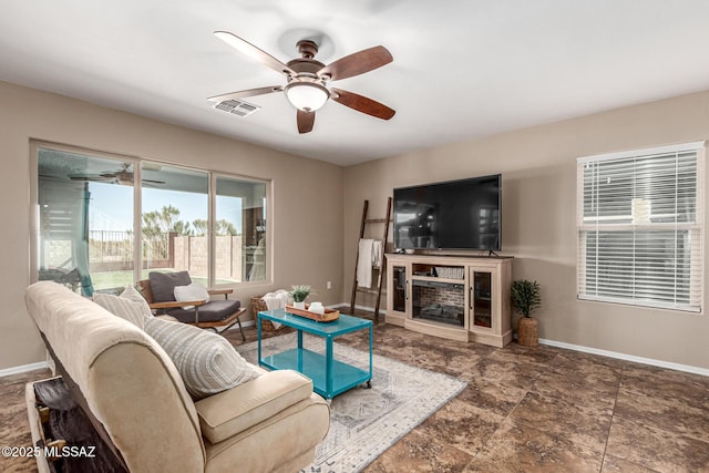 9528 S Desert Fauna Loop, Tucson, AZ 85747 - living area featuring baseboards, a ceiling fan, and visible vents