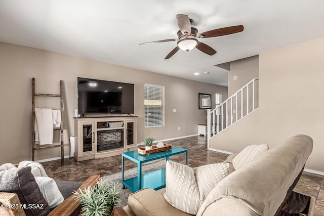 9528 S Desert Fauna Loop, Tucson, AZ 85747 - living area with stairway, ceiling fan, baseboards, and a fireplace