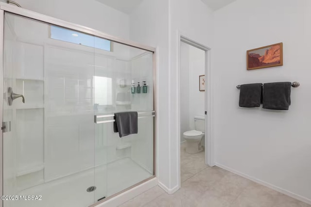 full bath with a shower stall, toilet, and baseboards