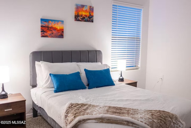 carpeted bedroom featuring baseboards