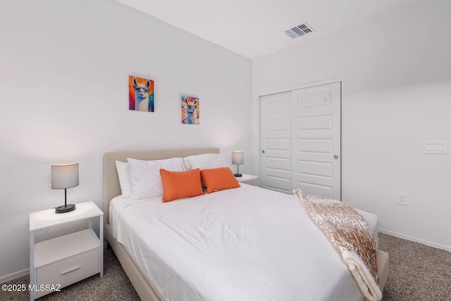 bedroom with a closet, carpet, visible vents, and baseboards