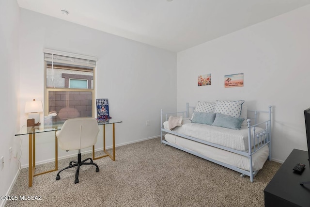 carpeted bedroom featuring baseboards