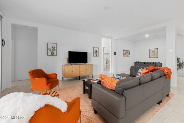 living area with recessed lighting and light tile patterned floors