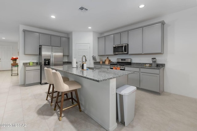 kitchen featuring gray cabinets, appliances with stainless steel finishes, and a sink