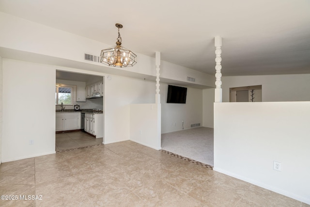 2826 W Jacinto St, Tucson, AZ 85745 - unfurnished living room featuring a sink and a chandelier