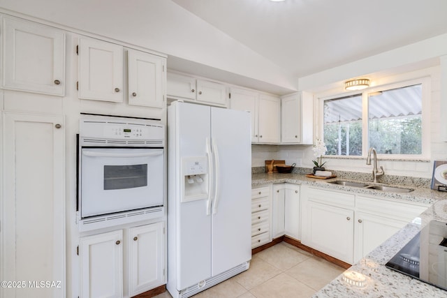 2826 W Jacinto St, Tucson, AZ 85745 - kitchen with white appliances, a sink, vaulted ceiling, white cabinetry, and light stone counters