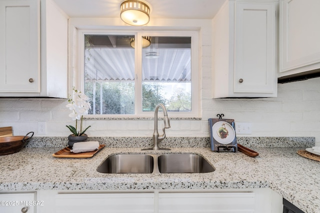 2826 W Jacinto St, Tucson, AZ 85745 - kitchen with a sink, white cabinetry, tasteful backsplash, and light stone counters