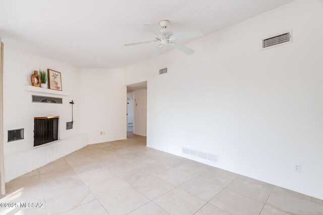 2826 W Jacinto St, Tucson, AZ 85745 - unfurnished living room featuring a brick fireplace, a ceiling fan, baseboards, and light tile patterned floors