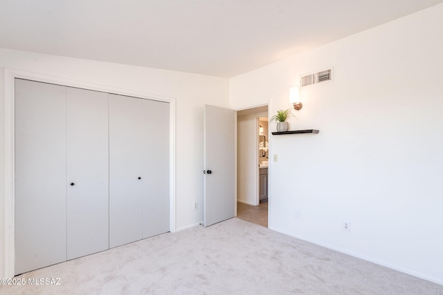 2826 W Jacinto St, Tucson, AZ 85745 - unfurnished bedroom with light carpet, a closet, and baseboards