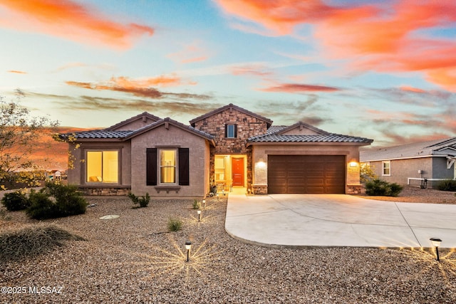5596 W Lazy Farm Dr, Tucson, AZ 85742 - view of front of property featuring a tile roof, driveway, stucco siding, stone siding, and a garage