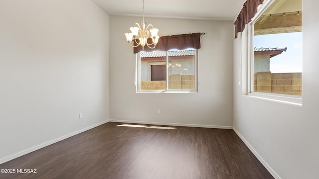 12693 N Rye Dr, Marana, AZ 85653 - spare room featuring a chandelier, dark wood-type flooring, baseboards, and lofted ceiling
