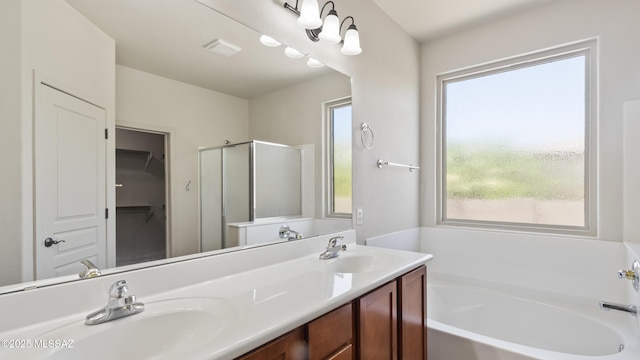 12693 N Rye Dr, Marana, AZ 85653 - full bathroom with a garden tub, a shower stall, double vanity, and a spacious closet